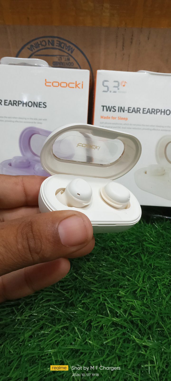 Toocki sleep earphones held in hand for size comparison M F Chargers