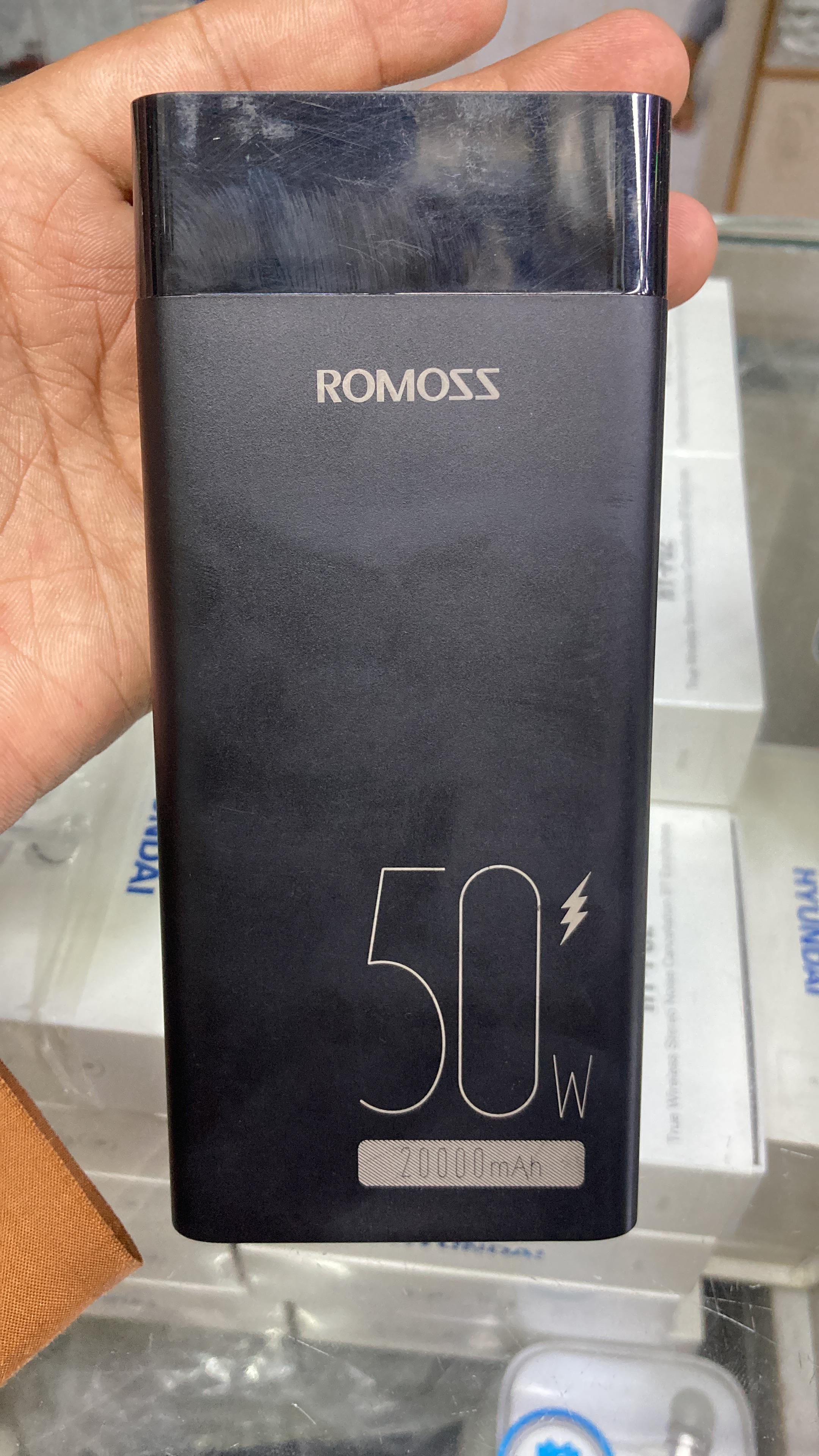 Front view of authentic black Romoss 50W 20000mAh power bank held in hand featuring the embossed ROMOSS logo.