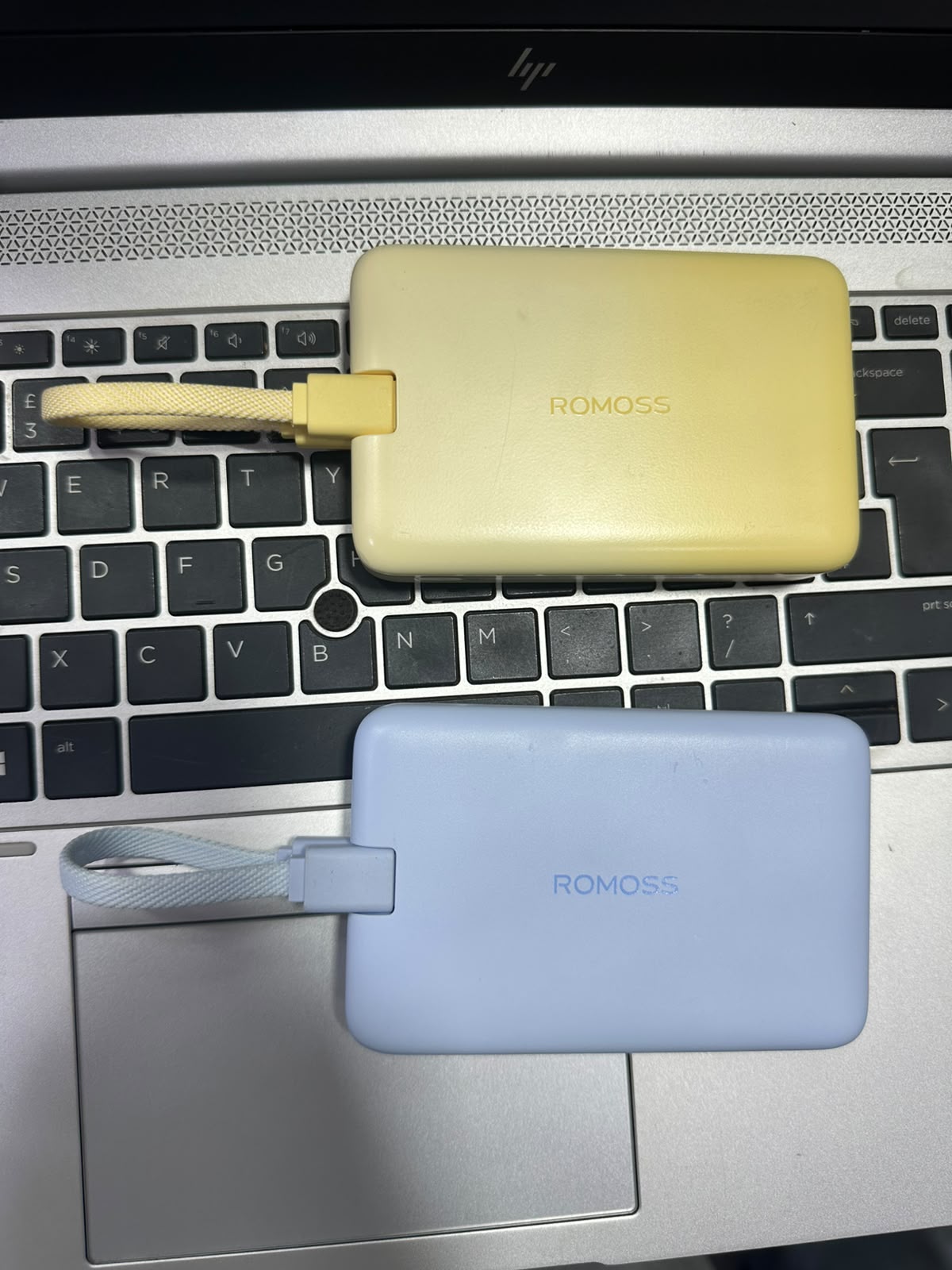 Romoss 10000mAh power banks kept on laptop keyboard - M F Chargers