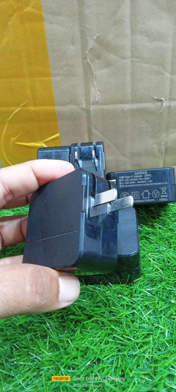 M F Chargers side angle showing the compact design and foldable pins of the 30W charger.