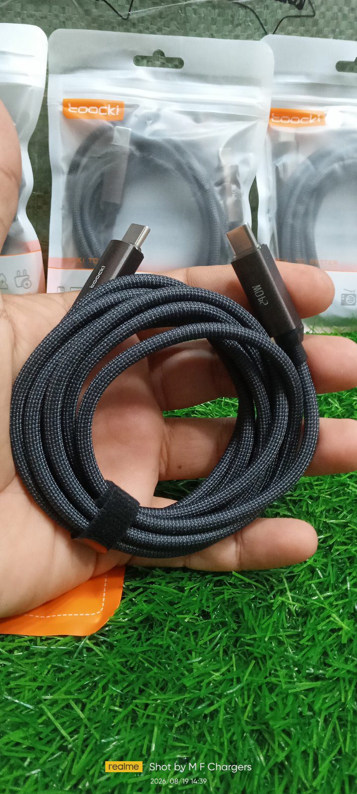 Coiled Toocki 240W 2M Type-C Cable held in hand close-up - M F Chargers