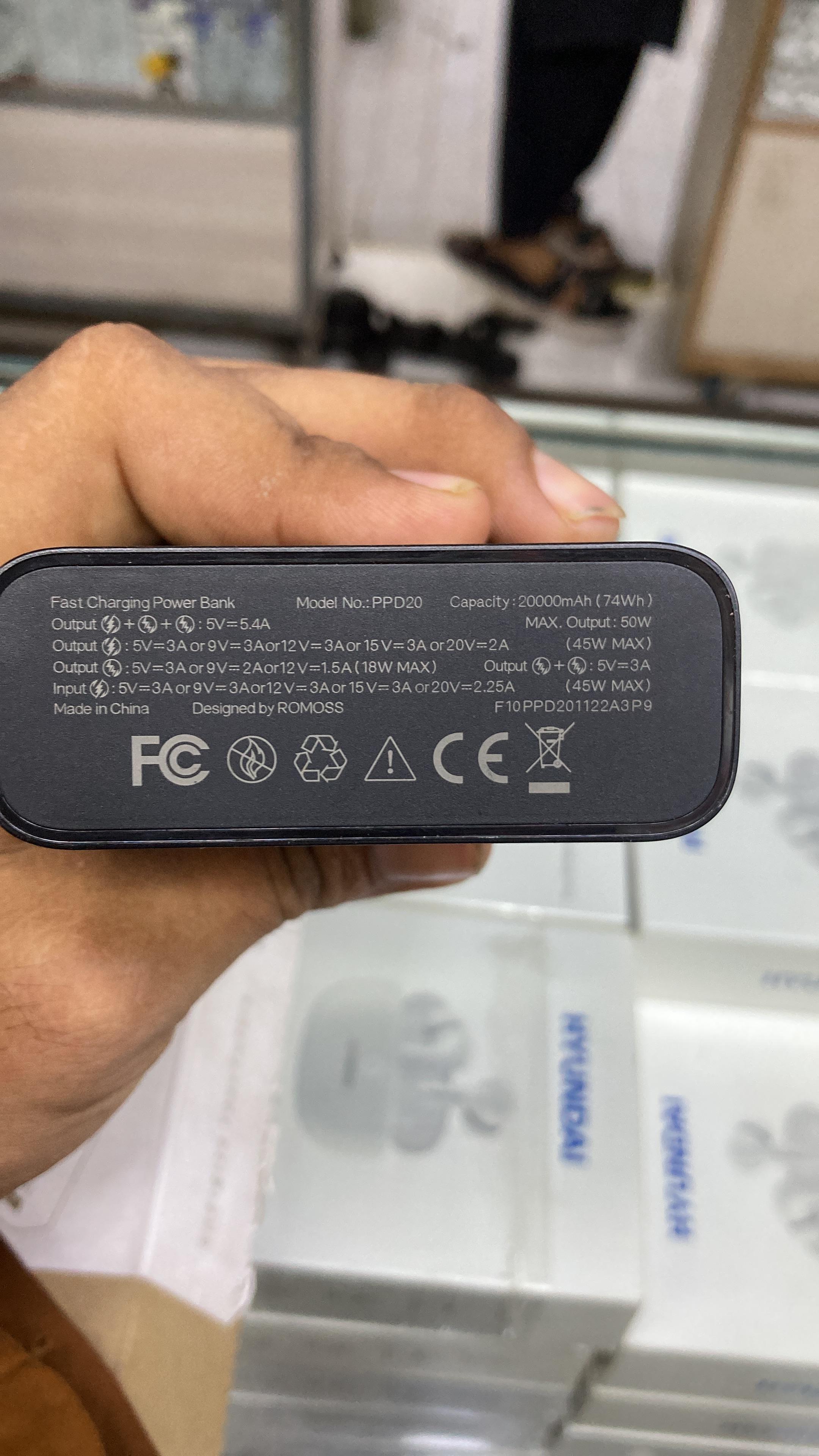 Detailed technical specifications printed on Romoss power bank Model PPD20 showing 20000mAh capacity and FCC CE certification marks.