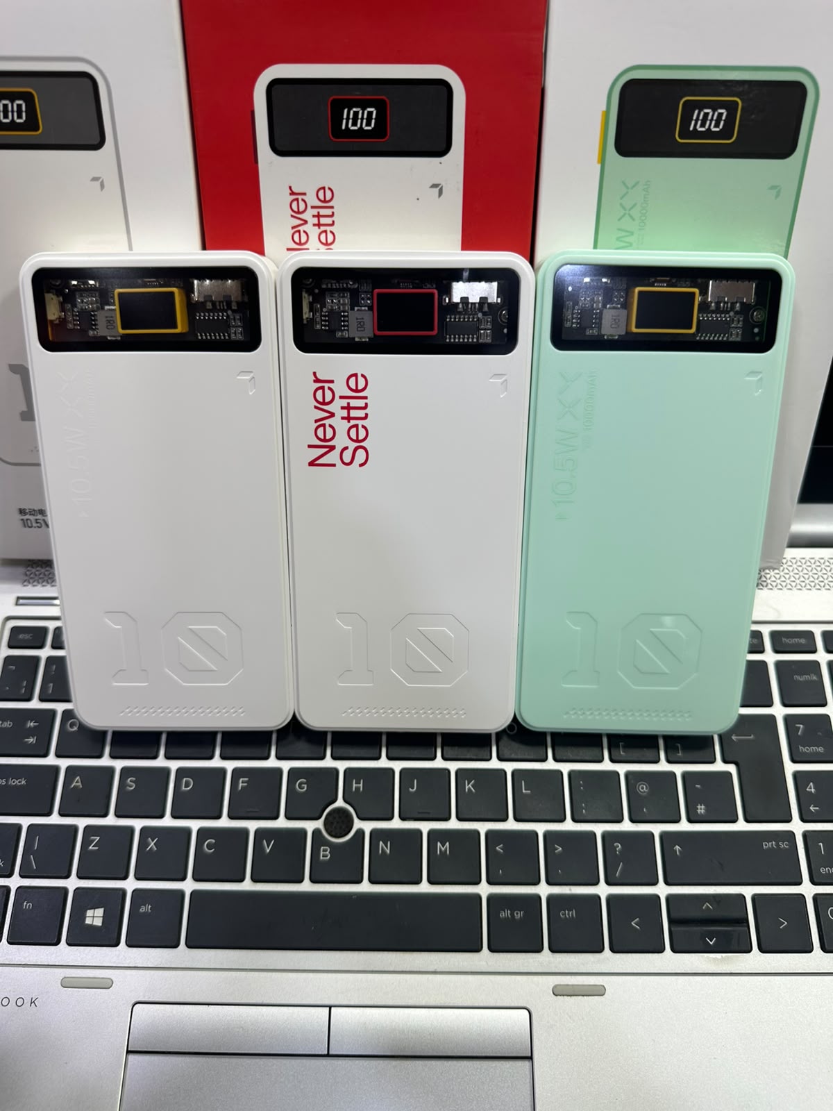 Mint green and white Yevon 10000mAh power banks standing on wooden table M F Chargers
