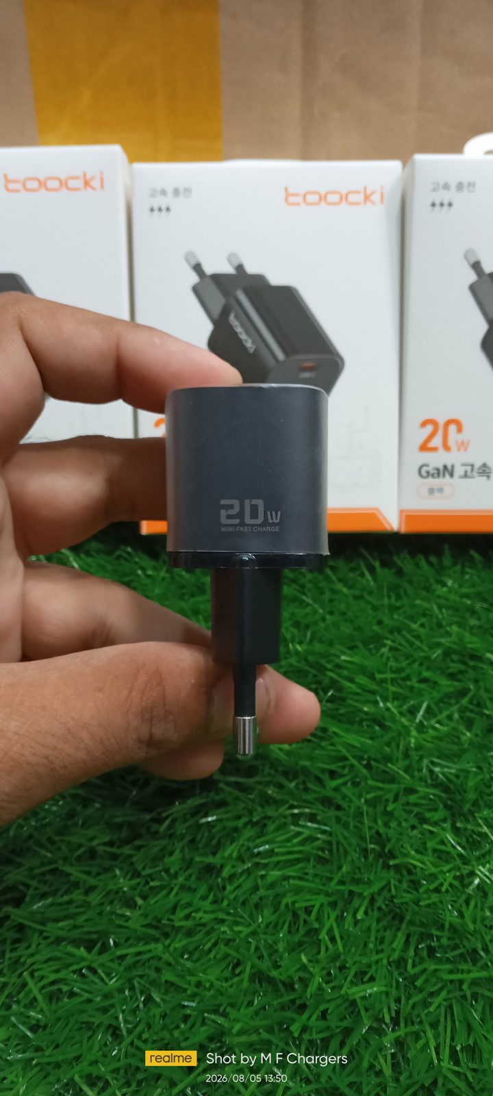 Hand holding Toocki 20W GaN Charger side profile showing 20W text - M F Chargers