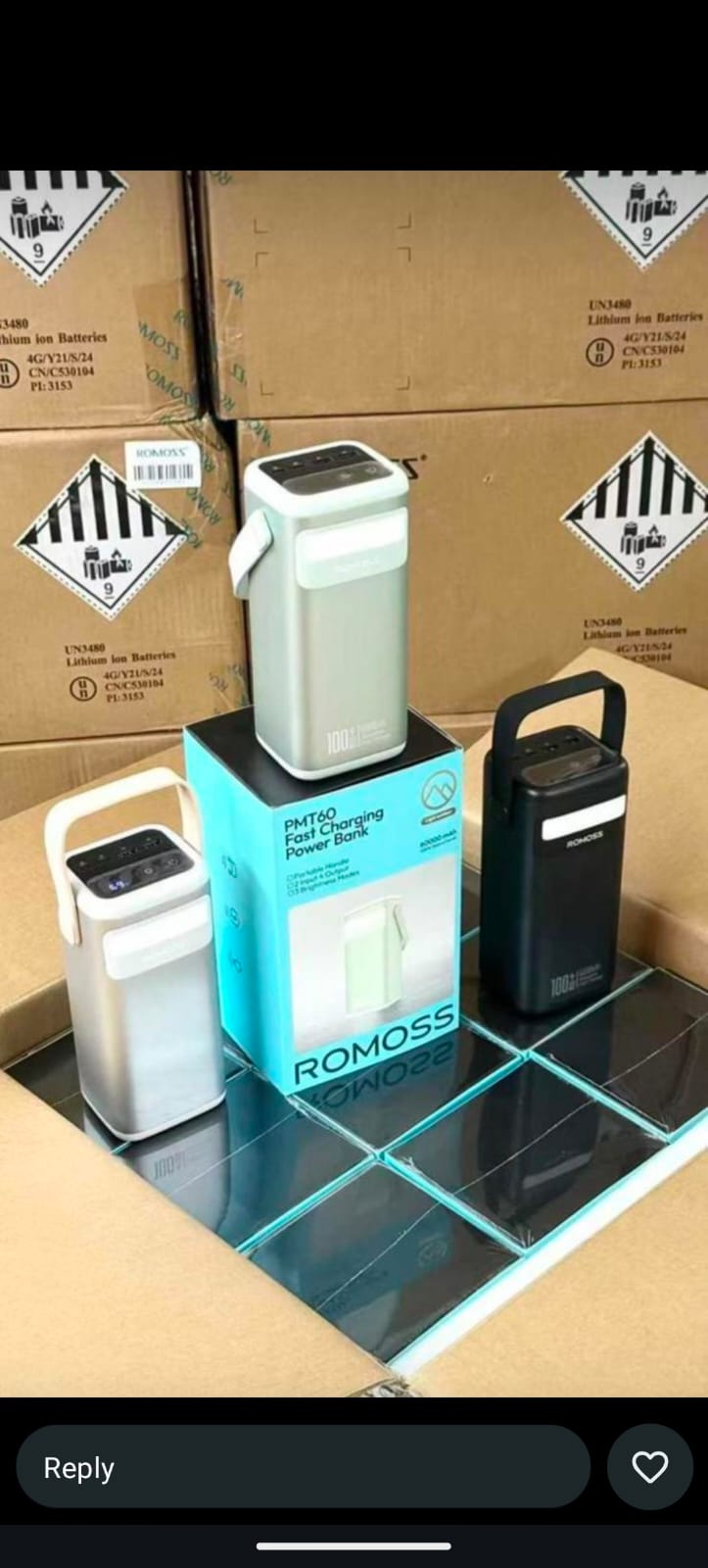 Multiple Romoss PMT60 60000mAh power bank units in black and silver colors displayed with their retail boxes on shipping cartons.