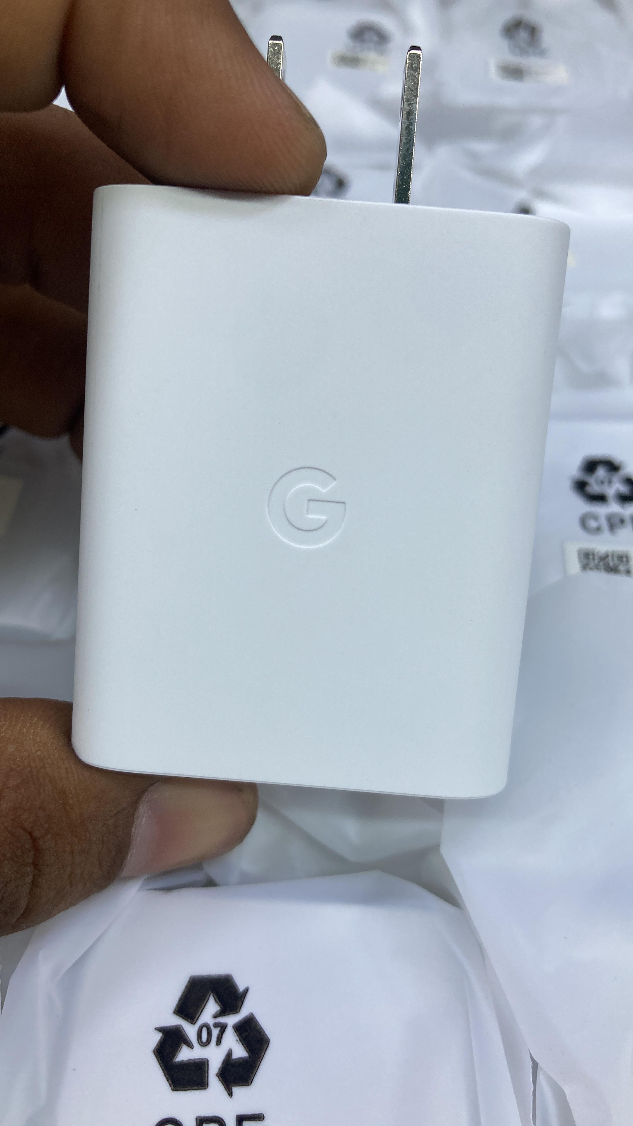 Clean front view of authentic white Google Pixel 30W fast charging adapter with embossed G logo.