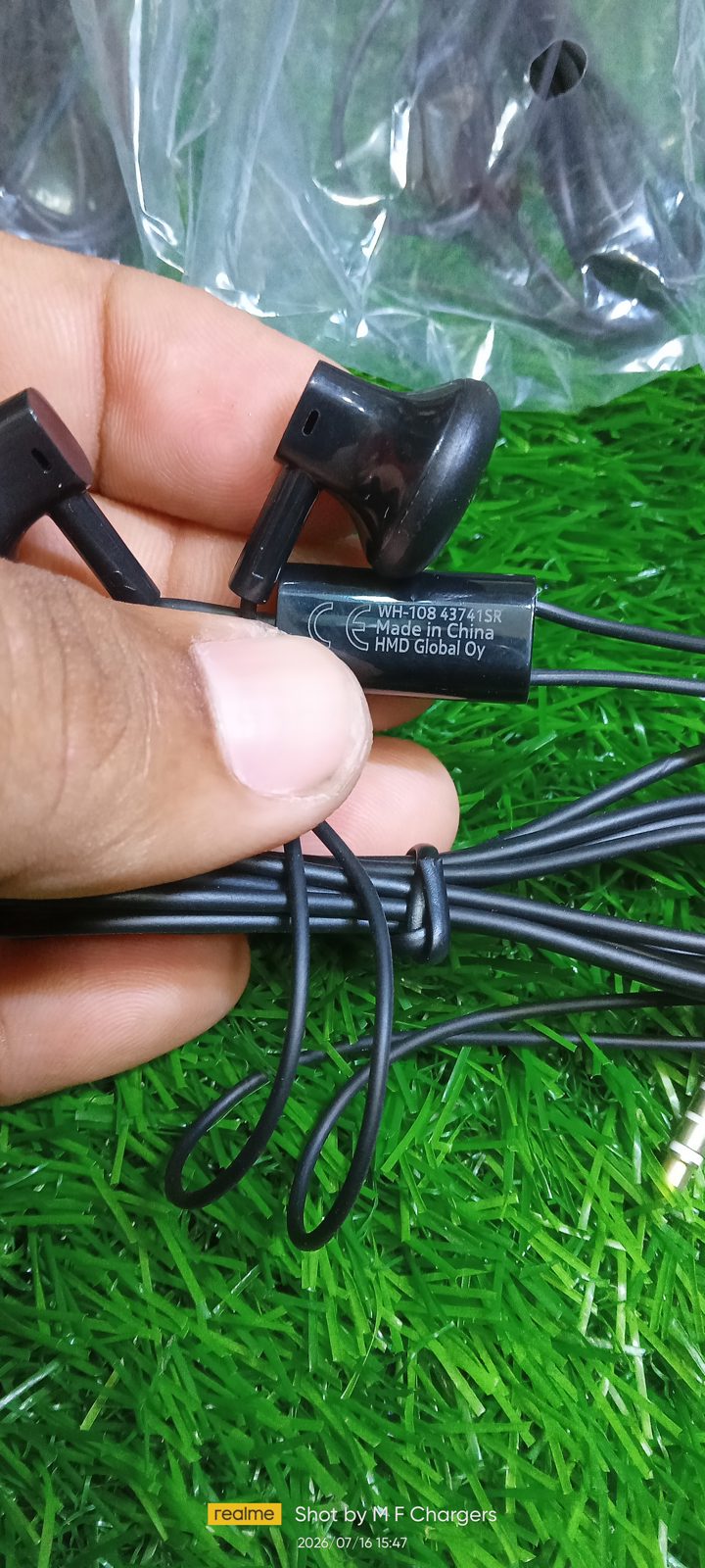 Close up of original Nokia WH-108 handsfree black wire holding in hand - M F Chargers