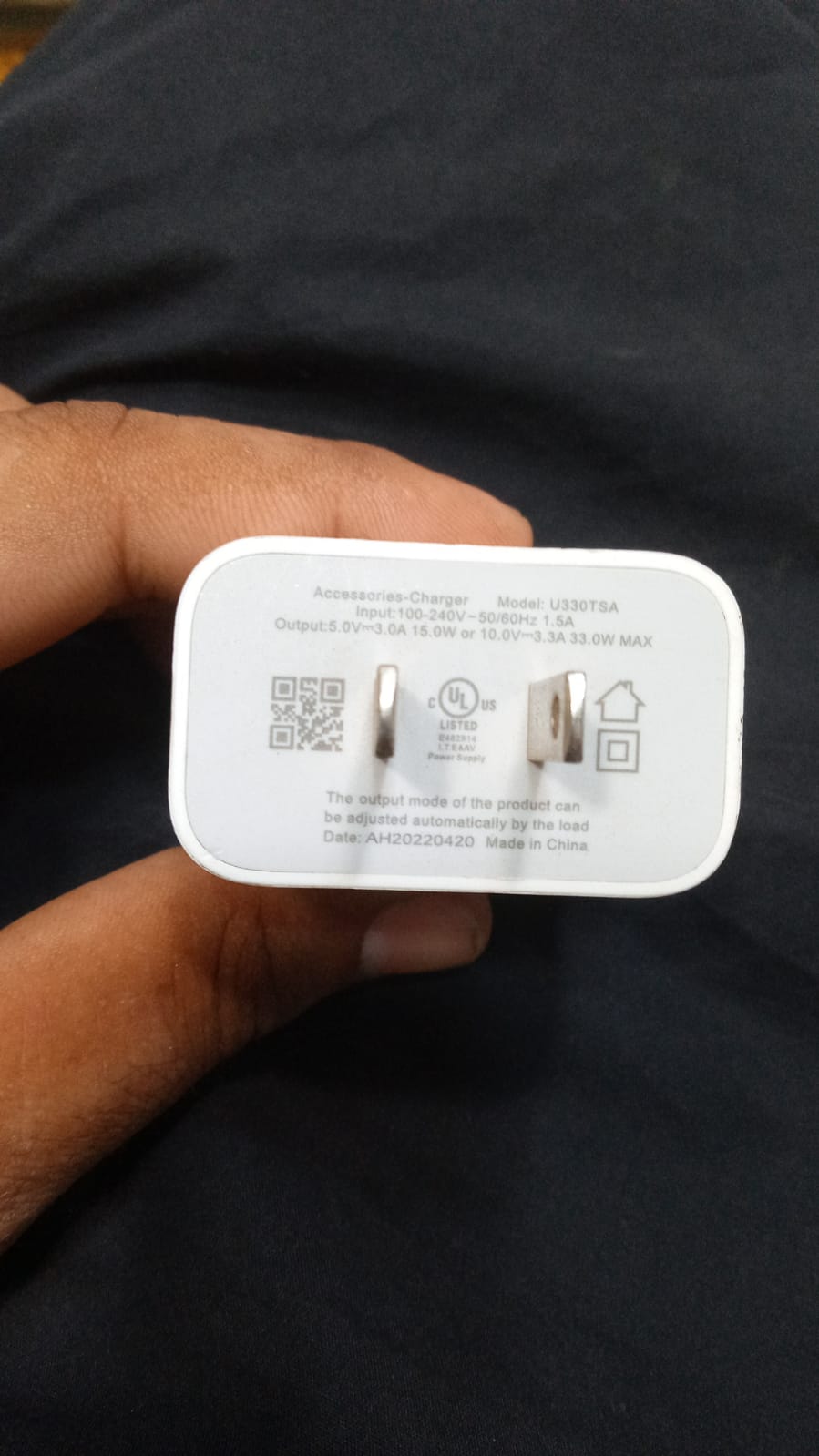 Back side of Tecno charger Model U330TSA showing input output power specifications and QR code for authenticity check.
