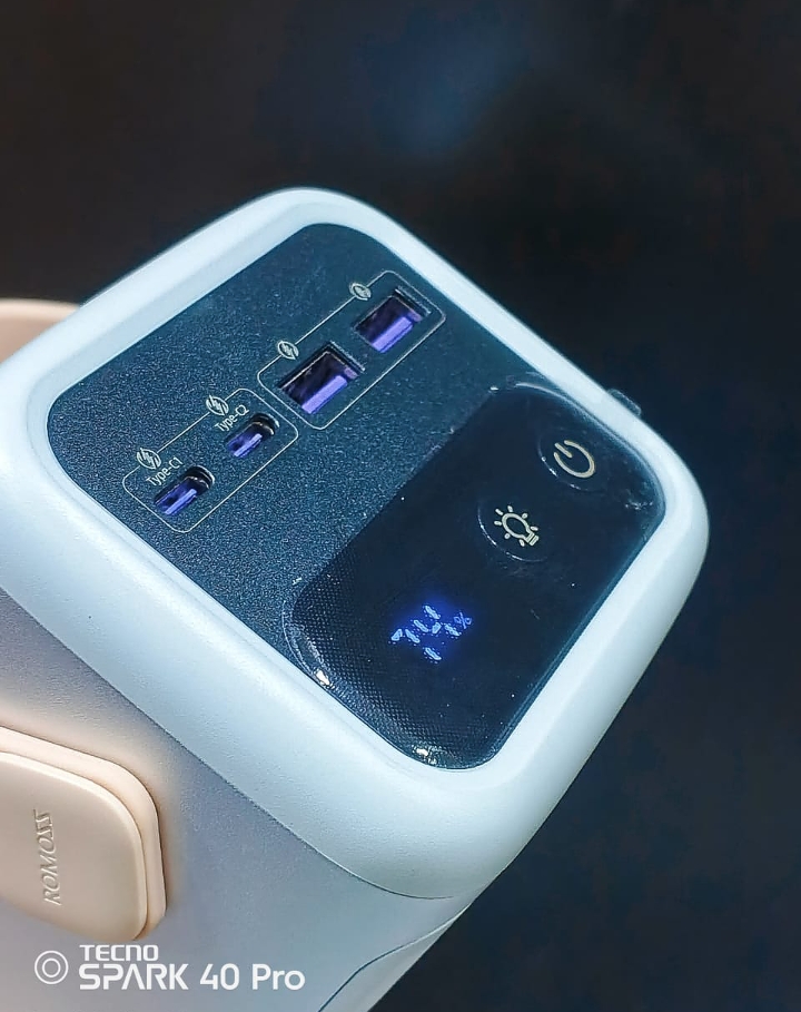 Close up top view of Romoss PMT60 power bank interface showing dual Type-C ports, dual USB-A ports, power buttons, and digital LED percentage display.