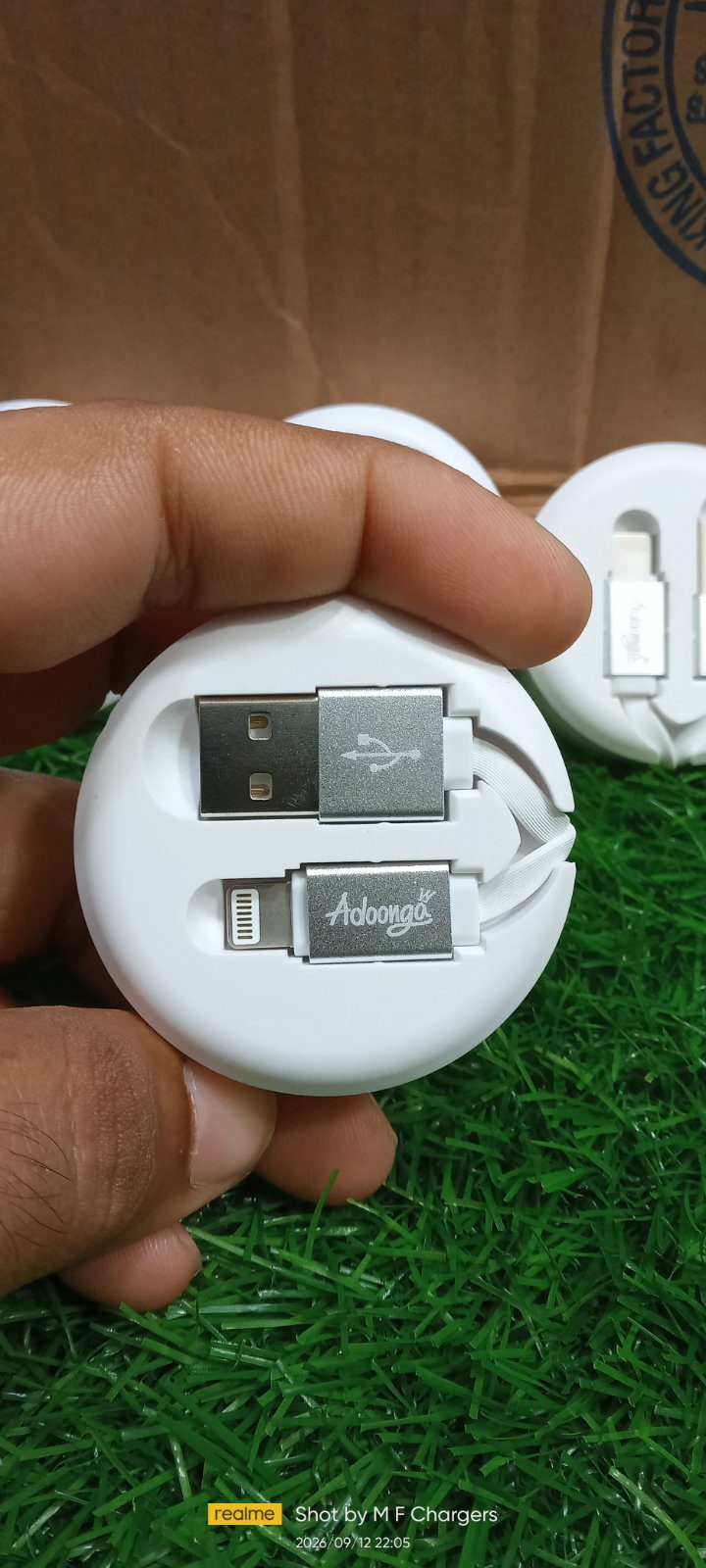 Compact white round cable organizer case held in hand M F Chargers