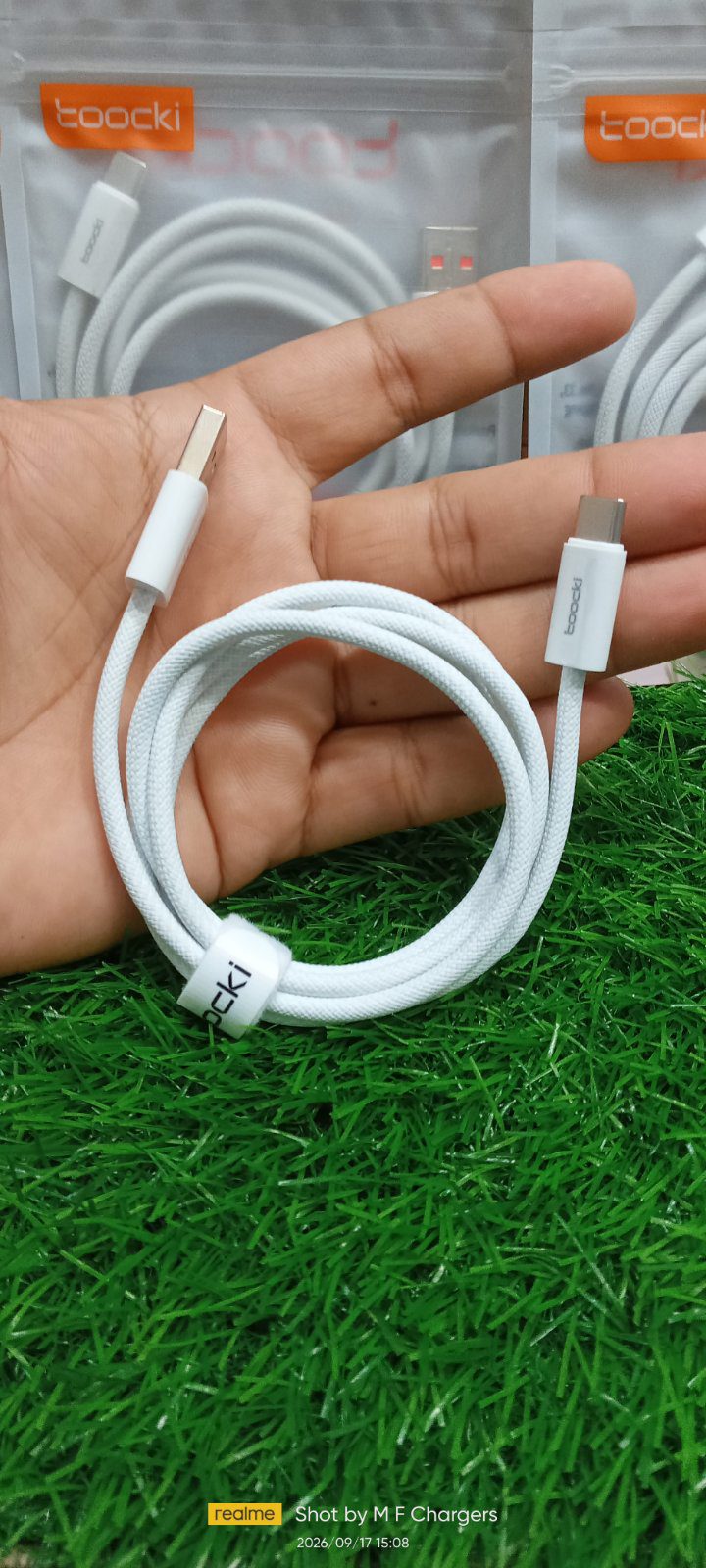 Premium white Toocki charging cable displayed on green grass background by M F Chargers