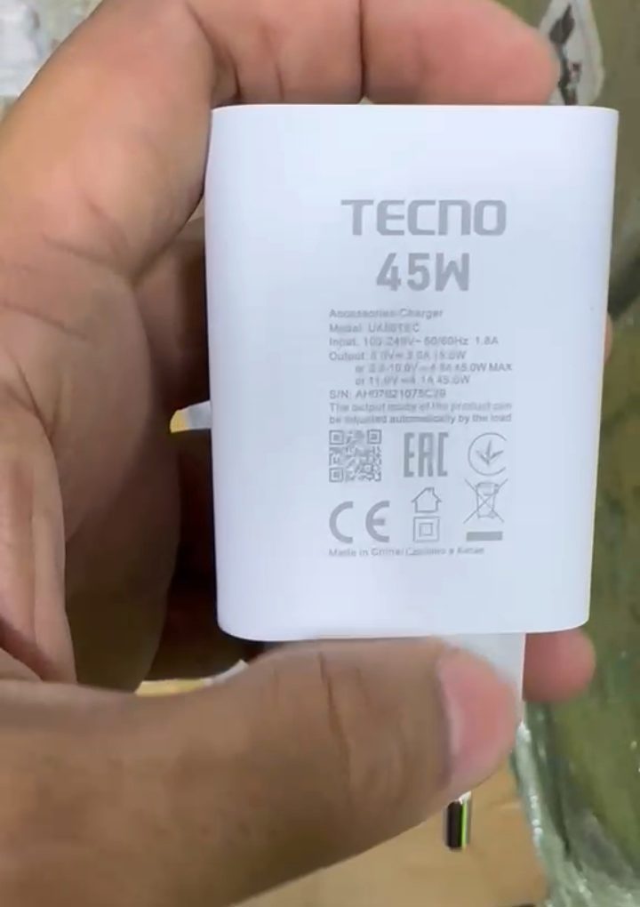 M F Chargers - Original Tecno 45W charger being held in hand