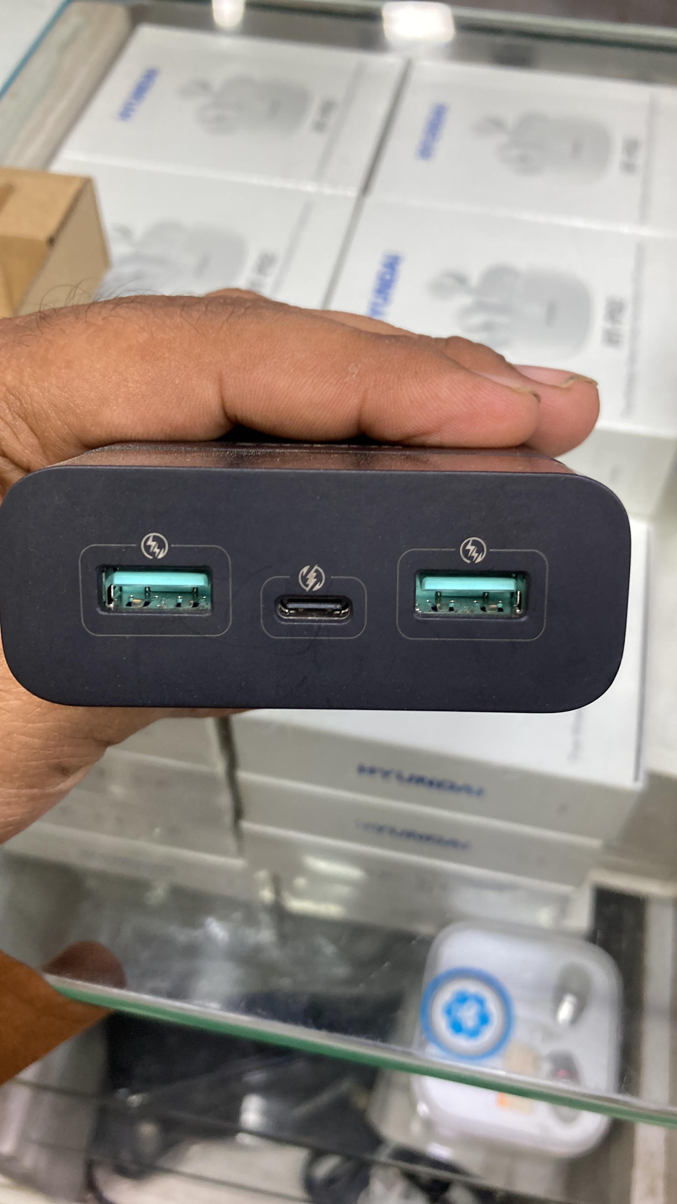 Top angle view of Romoss 50W power bank showing 3 charging ports including two green USB Type-A ports and one USB Type-C port.