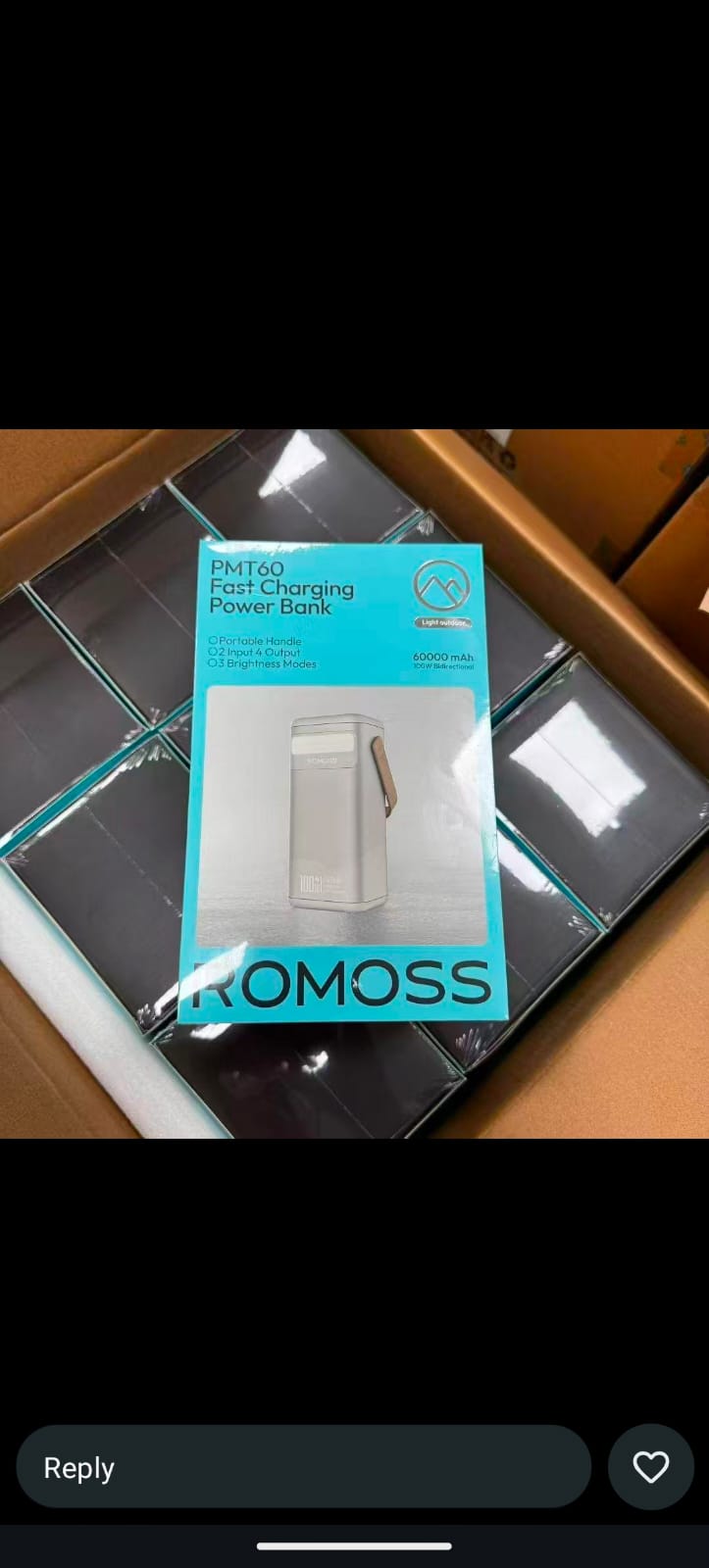 Blue and white Romoss PMT60 fast charging 60000mAh power bank retail packaging box inside a delivery carton.