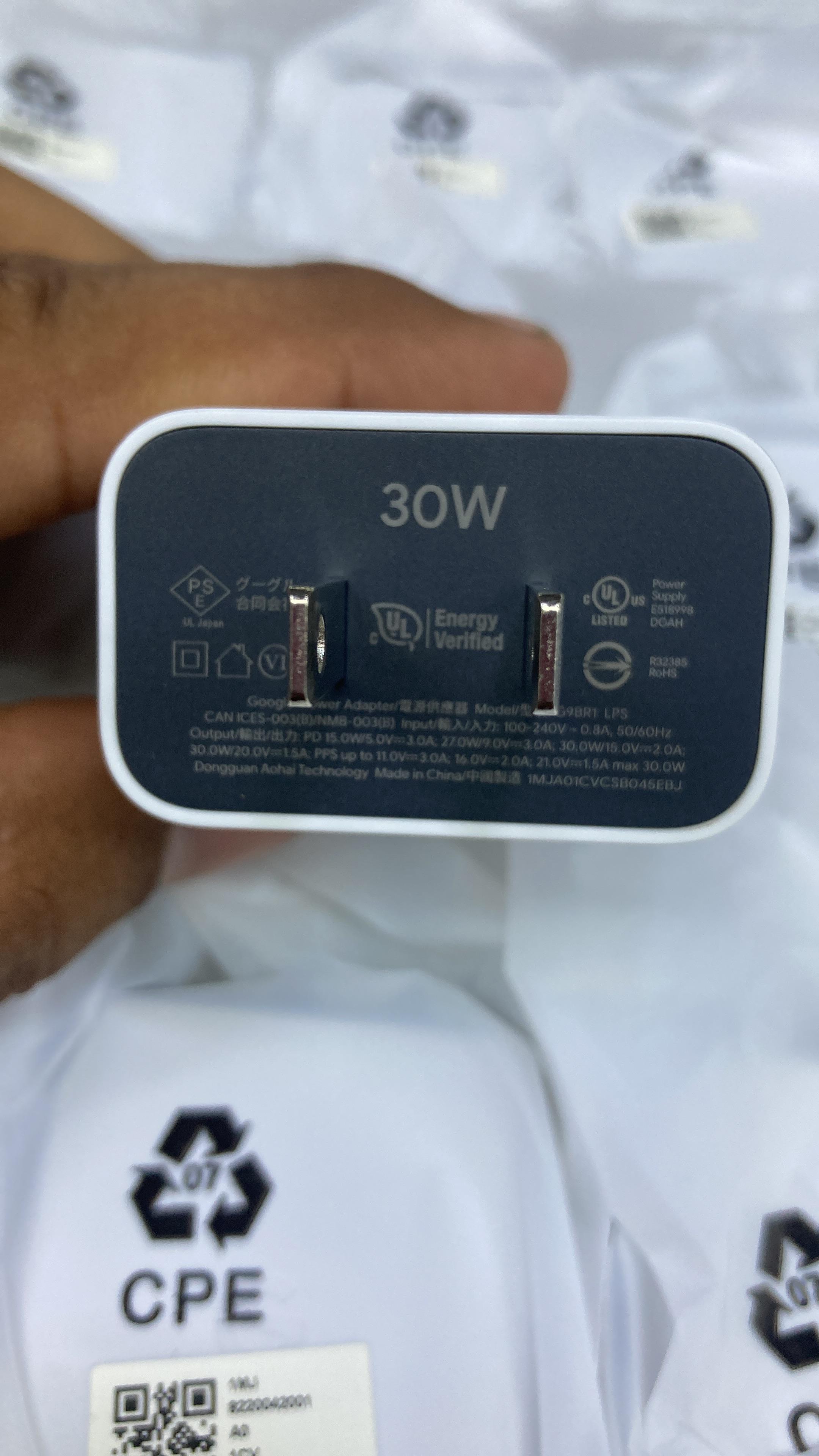 Close up view of Google Pixel 30W power adapter specifications showing UL Energy Verified text and regulatory symbols.
